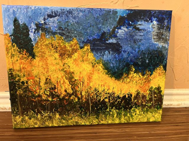 Fall aspens next to a range of moutains